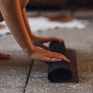 Close up of hands stretching on a mat